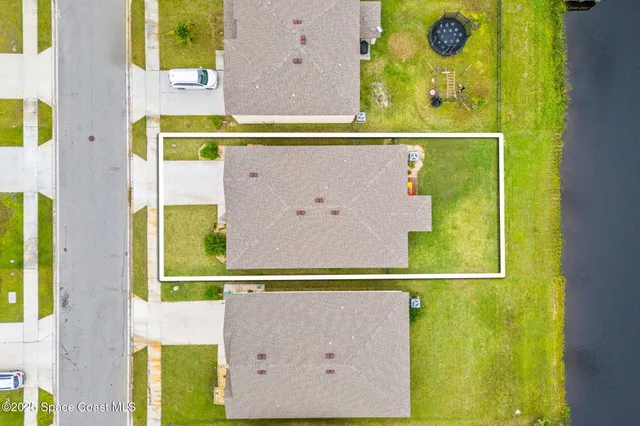 a aerial view of a house with a swimming pool yard and outdoor seating