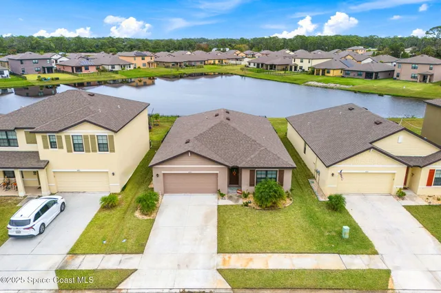 an aerial view of residential houses with outdoor space and swimming pool