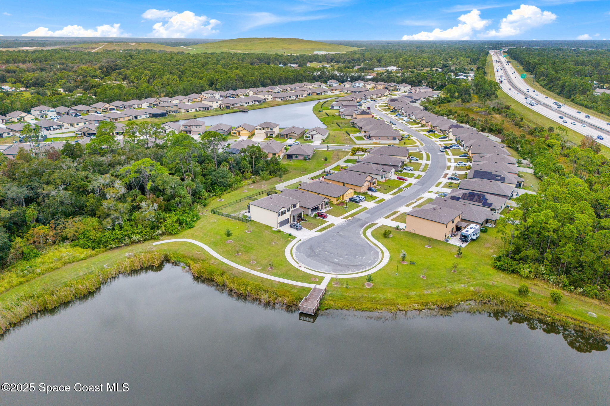 4901 Talbot Boulevard Cocoa, FL 32926 - Photo 35 of 39 a view of a swimming pool with a lot of trees in the background