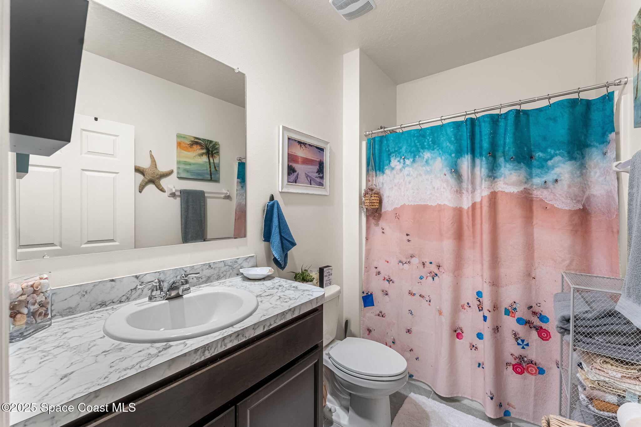 4901 Talbot Boulevard Cocoa, FL 32926 - Photo 6 of 39 a bathroom with a sink toilet and shower curtain