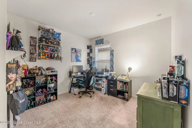 a view of a room with workspace and a window