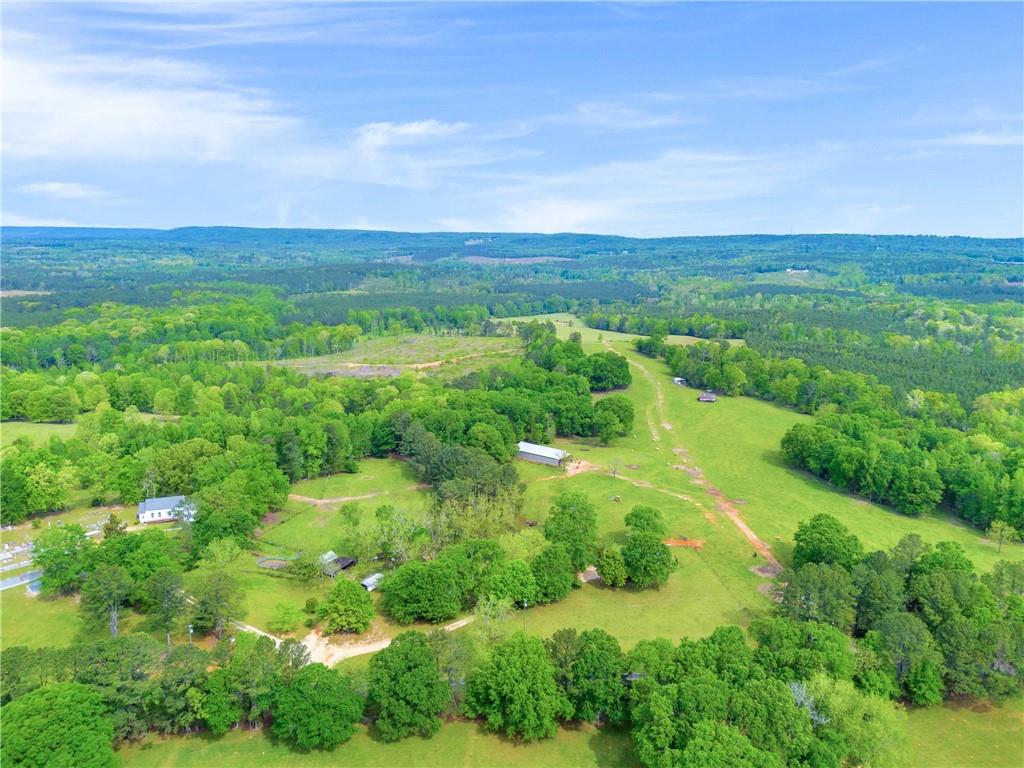 2450 Chestnut Grove Road Shiloh, GA 31826 - Photo 25 of 46 a view of a lush green outdoor space with a swimming pool and valleys in the background