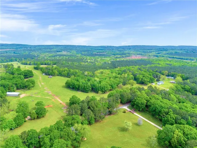 a backyard of a house with lots of green space and mountain view in back