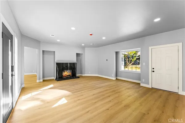 a view of an empty room with a fireplace