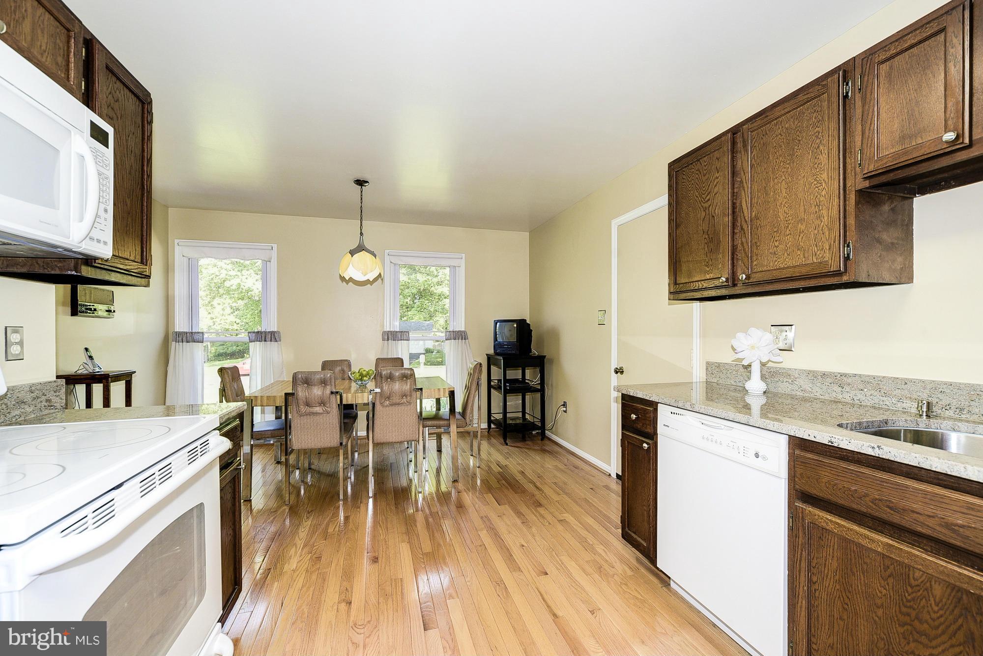 15013 Wellwood Road Silver Spring, MD 20905 - Photo 12 of 30 a view of a dining room with furniture window and wooden floor