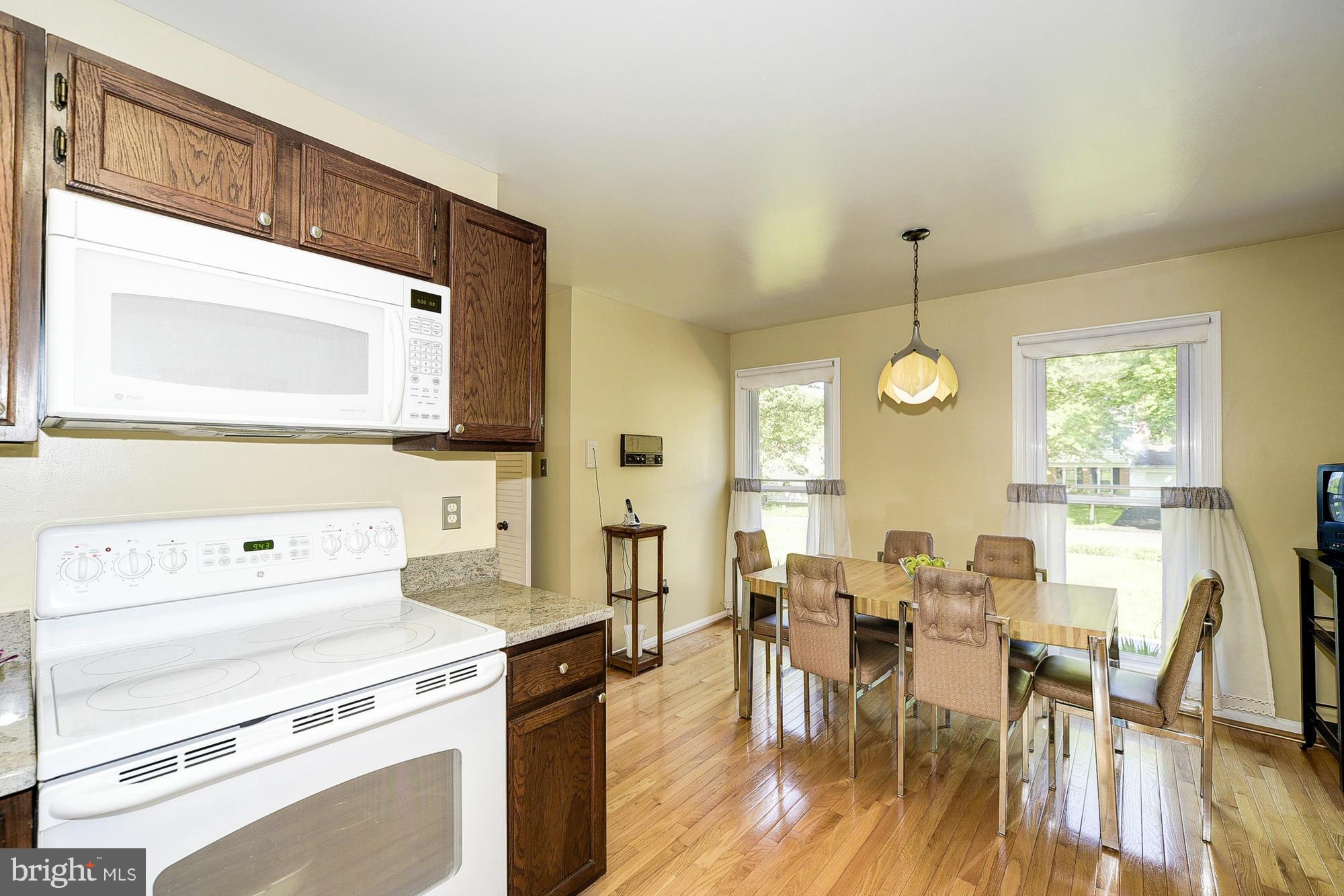 15013 Wellwood Road Silver Spring, MD 20905 - Photo 13 of 30 a view of a dining room and chairs and wooden floor