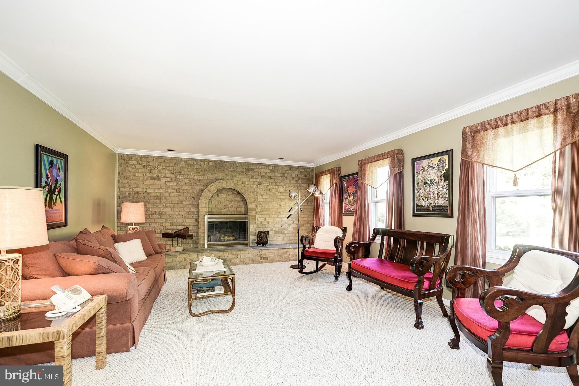 15013 Wellwood Road Silver Spring, MD 20905 - Photo 14 of 30 a living room with furniture and a fireplace