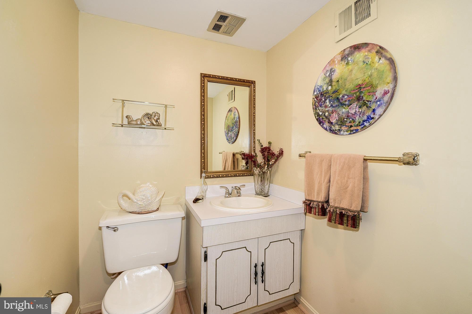 15013 Wellwood Road Silver Spring, MD 20905 - Photo 16 of 30 a bathroom with a toilet sink and mirror