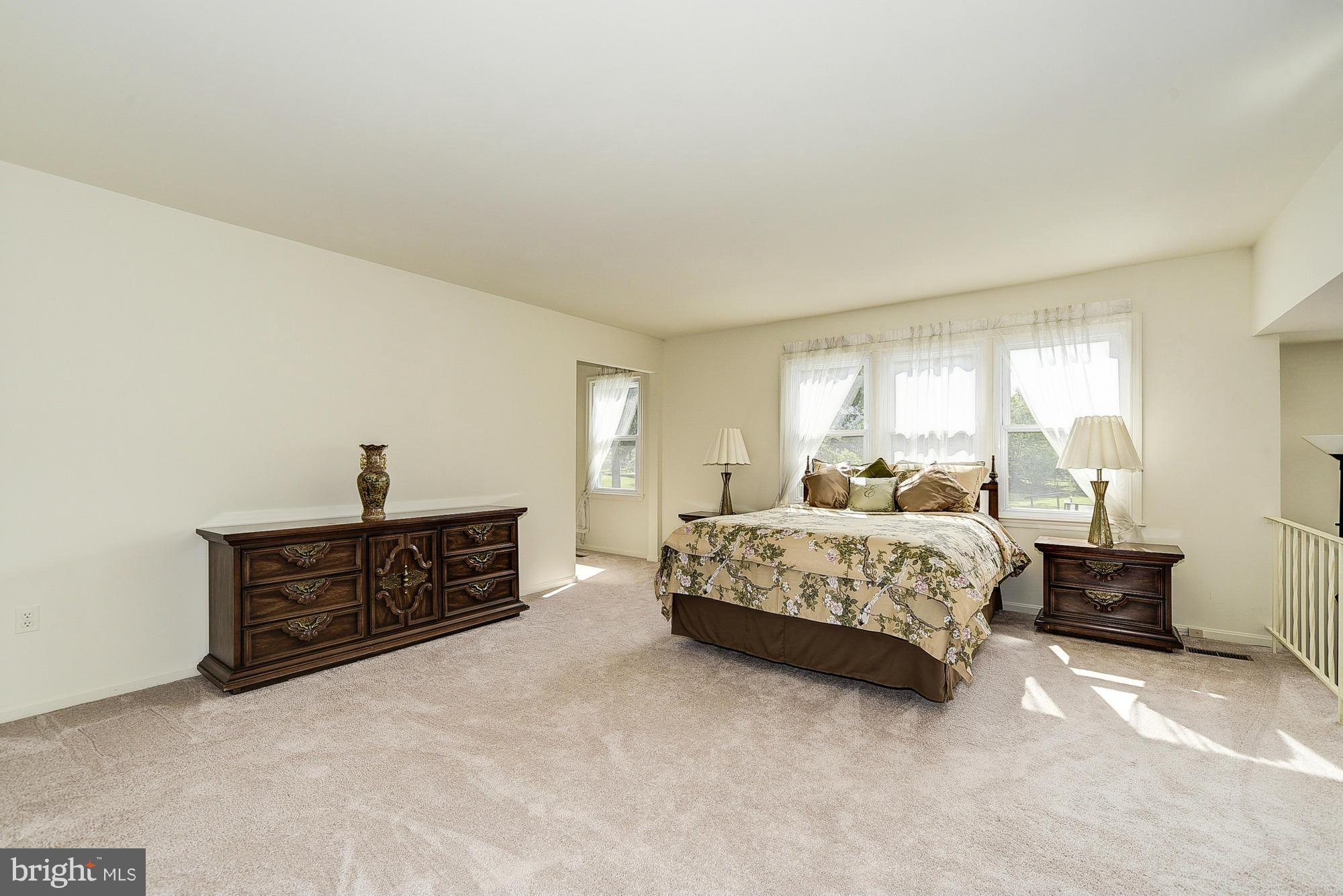 15013 Wellwood Road Silver Spring, MD 20905 - Photo 19 of 30 a spacious bedroom with a bed and window