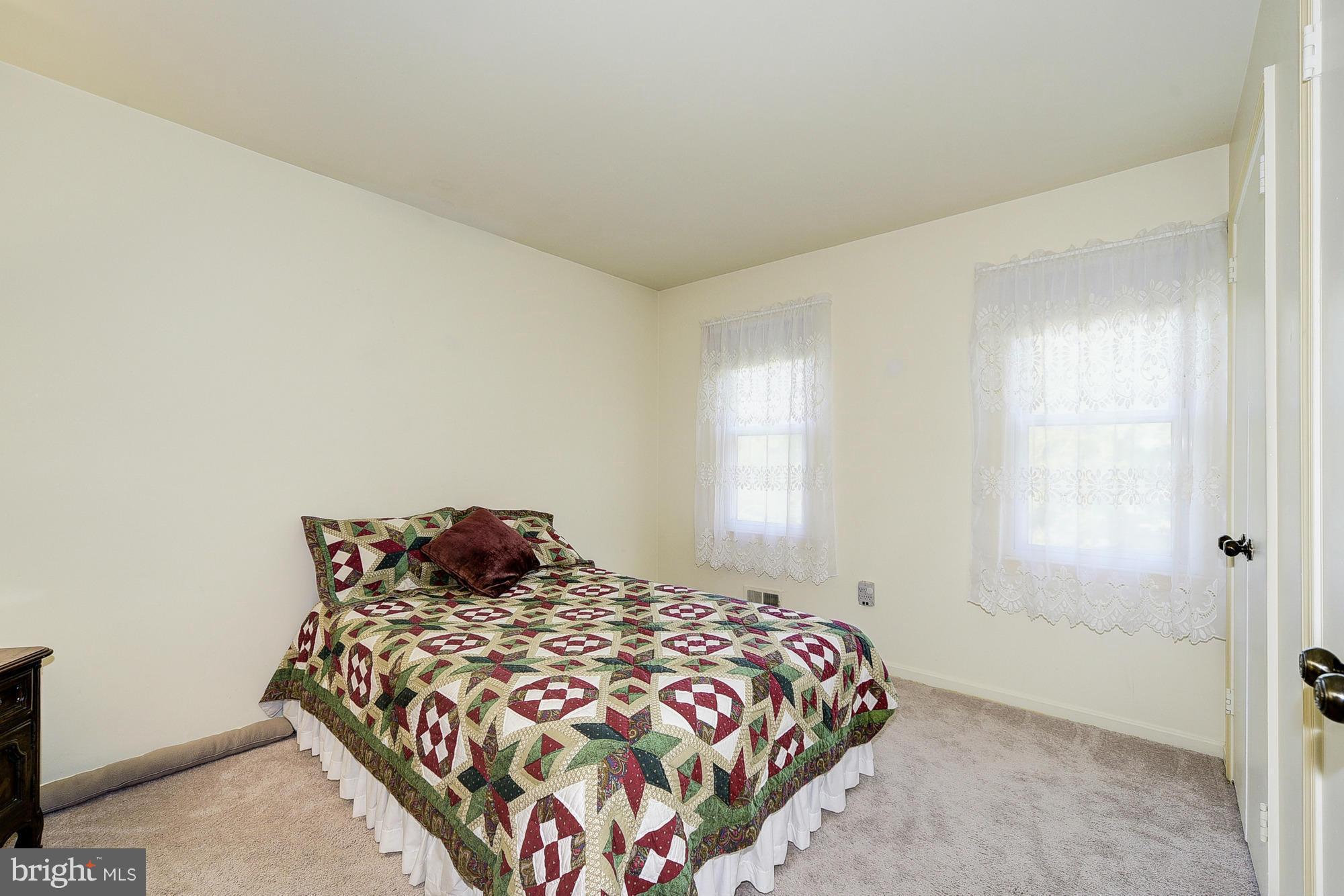 15013 Wellwood Road Silver Spring, MD 20905 - Photo 25 of 30 a bedroom with a bed and window
