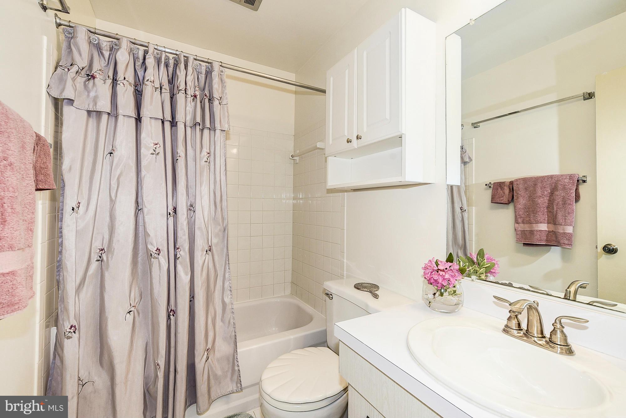 15013 Wellwood Road Silver Spring, MD 20905 - Photo 27 of 30 a bathroom with a sink toilet and shower