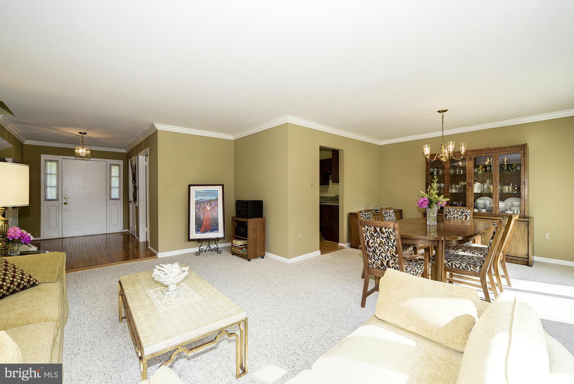 15013 Wellwood Road Silver Spring, MD 20905 - Photo 9 of 30 a living room with furniture a dining table and chairs