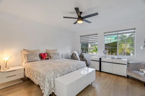 a bedroom with a bed and a painting on the wall