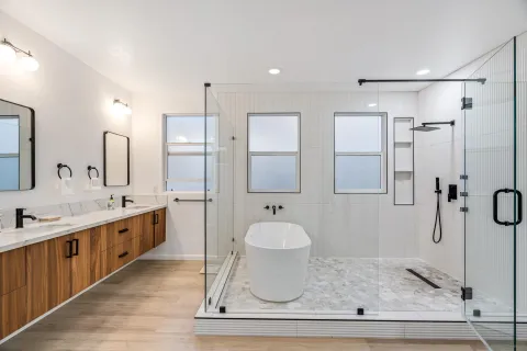 a spacious bathroom with a granite countertop shower a mirror and a sink