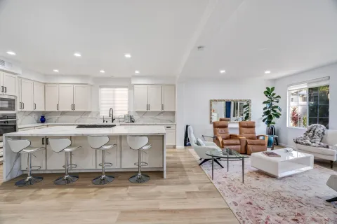a large white kitchen with a large window