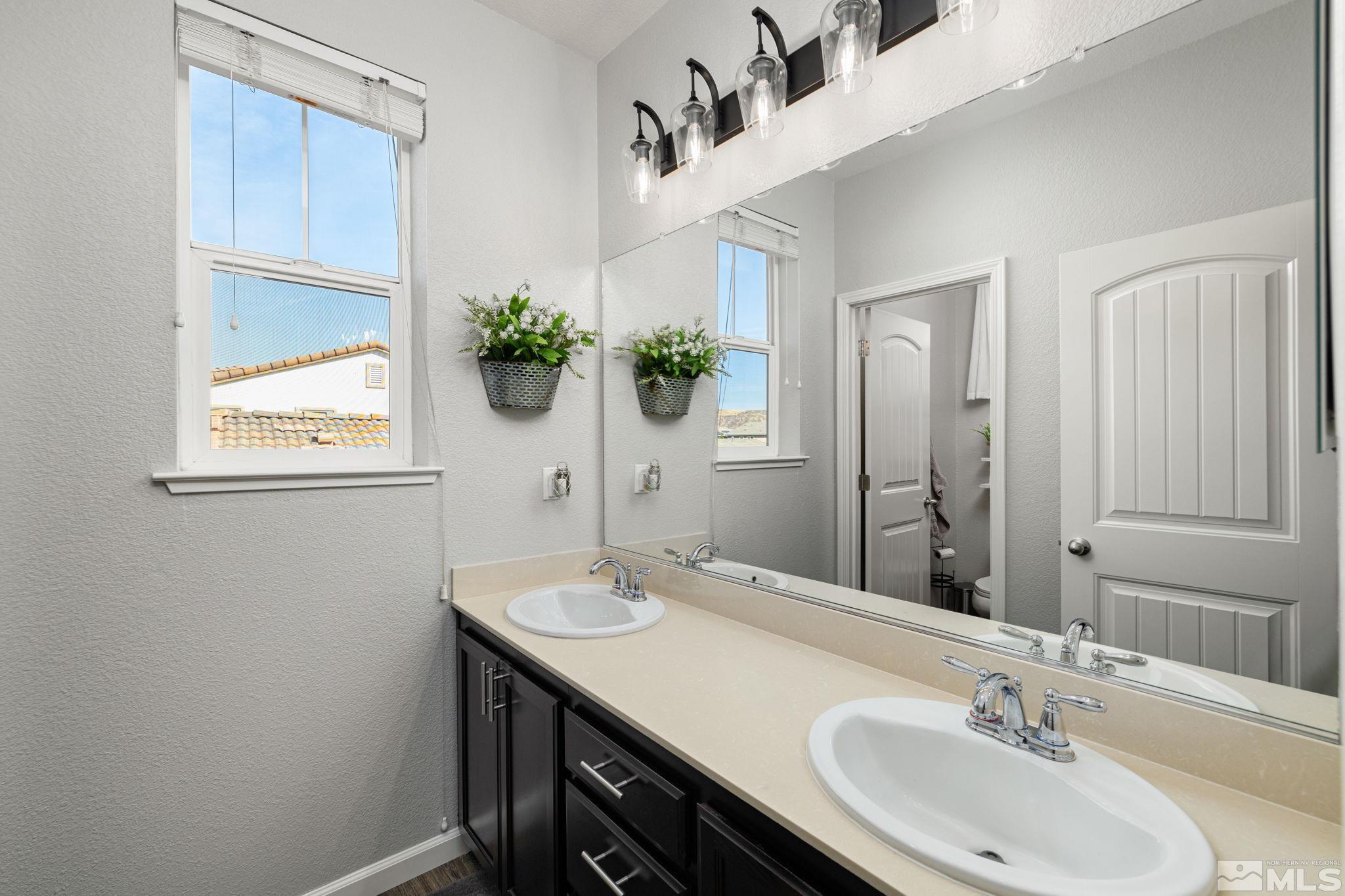 9390 Lost Valley Road Reno, NV 89521 - Photo 20 of 26 a bathroom with a sink and a mirror