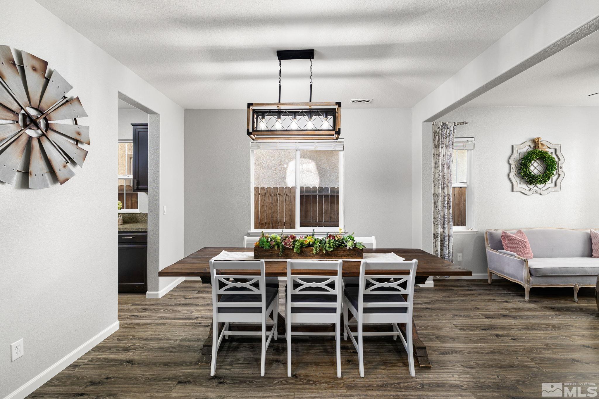 9390 Lost Valley Road Reno, NV 89521 - Photo 6 of 26 a dining room with furniture a chandelier and wooden floor