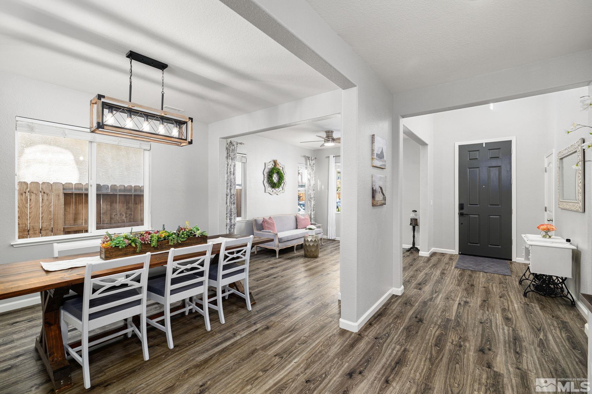 9390 Lost Valley Road Reno, NV 89521 - Photo 7 of 26 a view of a dining room with furniture window and wooden floor