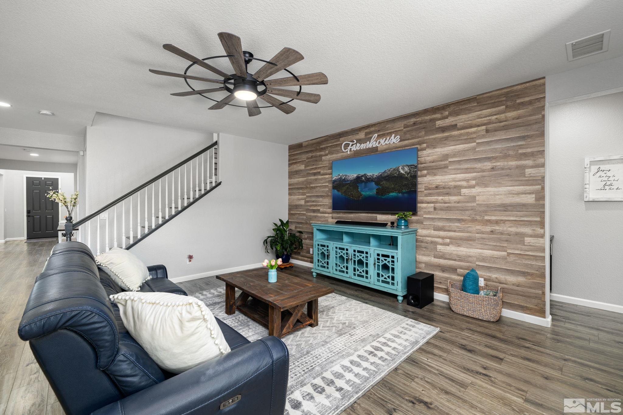 9390 Lost Valley Road Reno, NV 89521 - Photo 9 of 26 a living room with furniture a rug and a flat screen tv