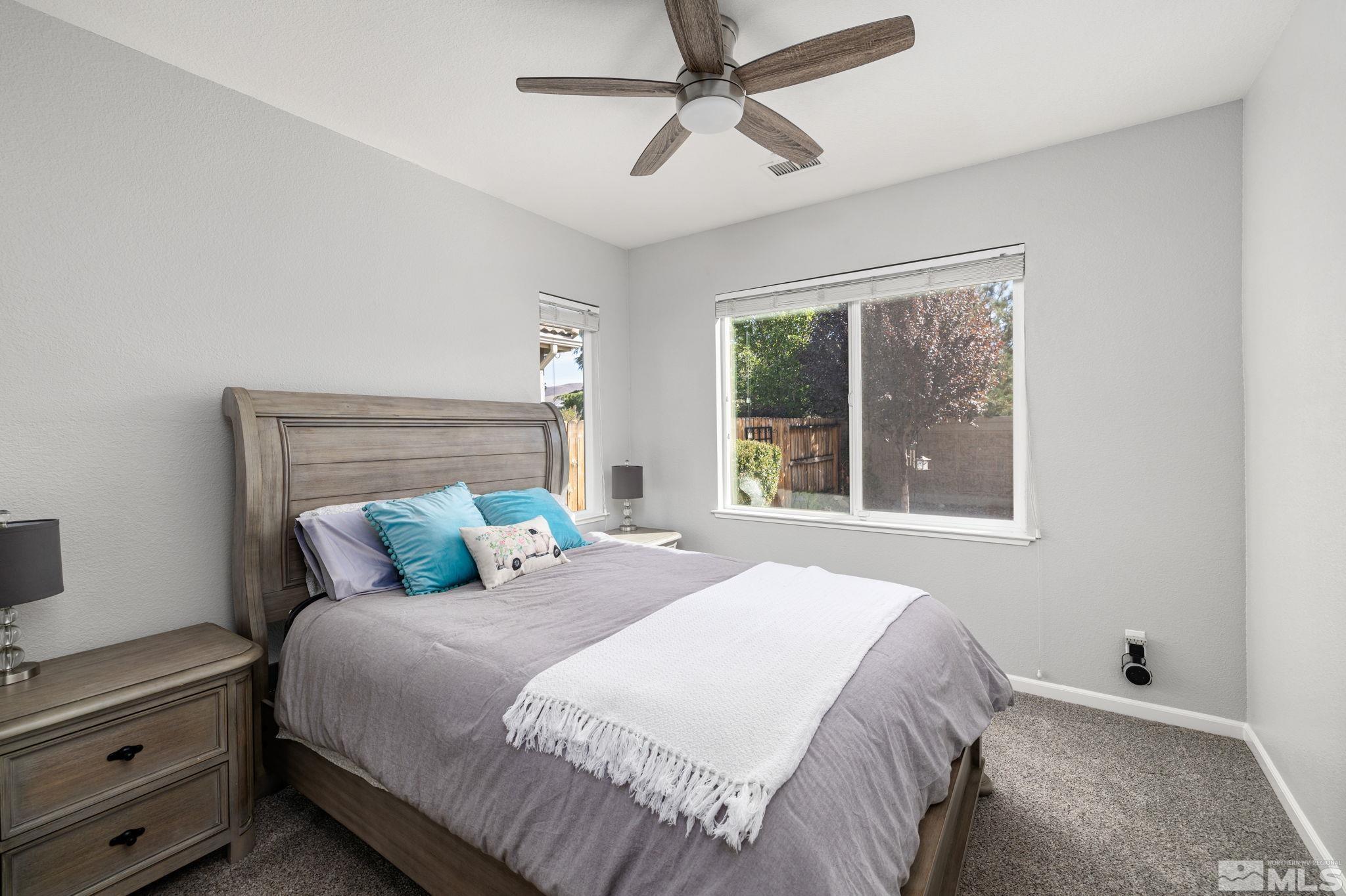 9390 Lost Valley Road Reno, NV 89521 - Photo 10 of 26 a bedroom with a large bed and a window