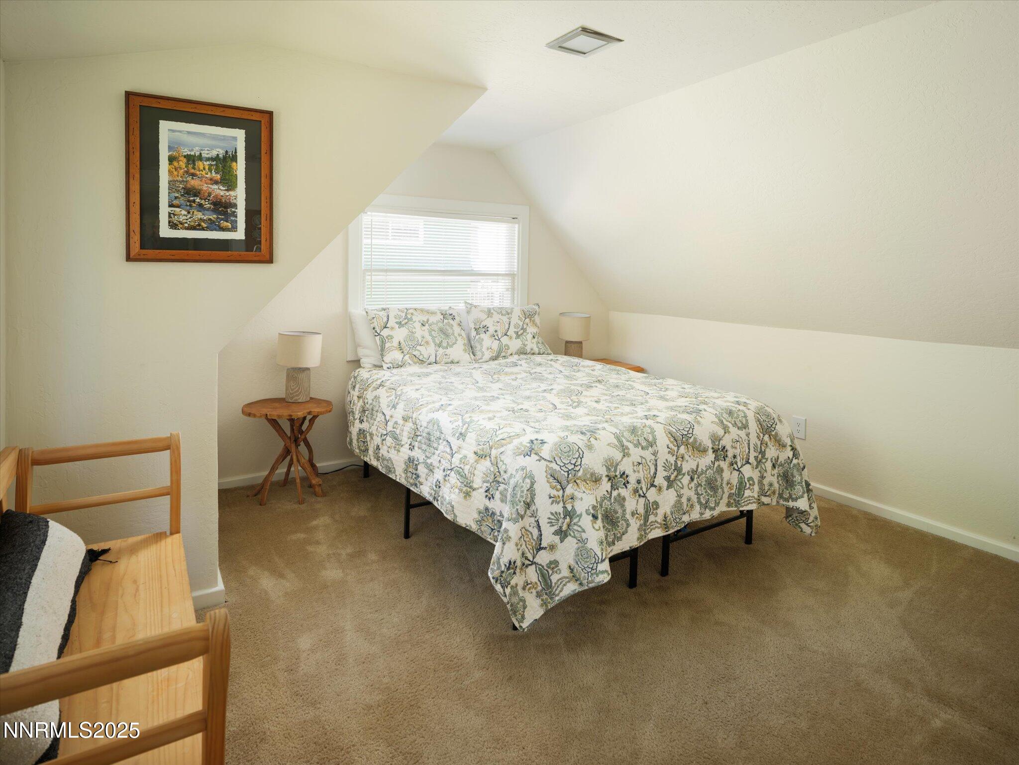 644 Job Lane Zephyr Cove, NV 89448 - Photo 12 of 26 a bedroom with a bed and a lamp on the dresser