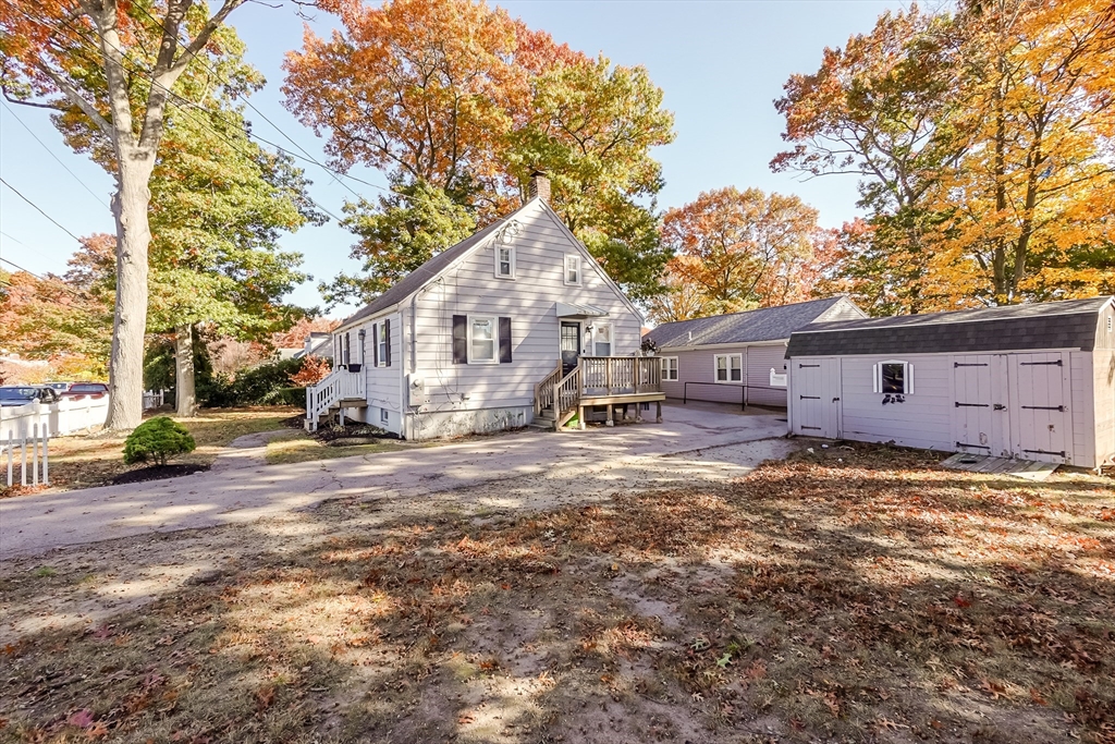 5 Oliver Street Randolph, MA 02368 - Photo 3 of 29 a view of a house with a yard covered in the forest