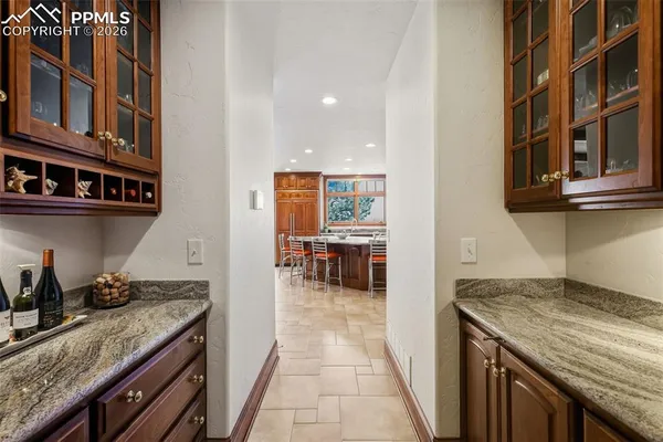 a kitchen with granite countertop lots of counter top space and wooden floor