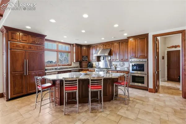 a kitchen with a sink a counter top stainless steel appliances and cabinets