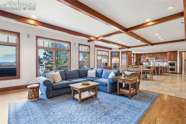 a living room with furniture a rug and a large window