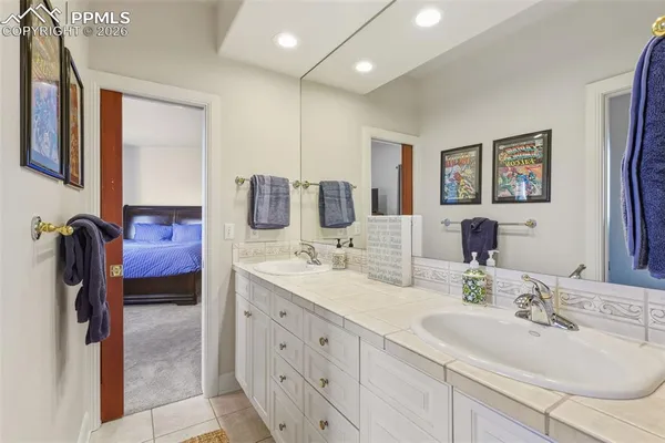 a bathroom with double vanity sinks and a mirror