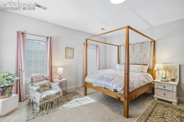 a bedroom with a bed and a couch