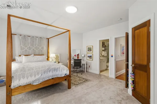 a bedroom with a bed and a mirror