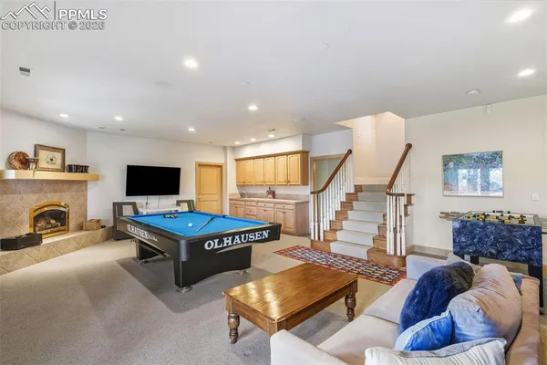 a living room with furniture a flat screen tv and a table