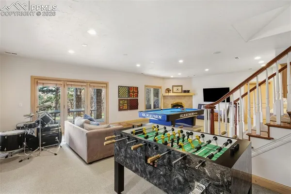 a living room with furniture fireplace and lots of windows