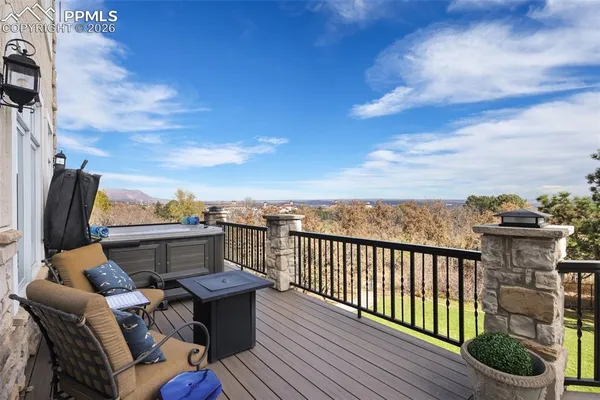 a view of a roof deck with furniture