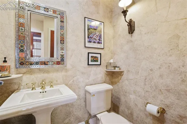 a bathroom with a sink mirror and toilet