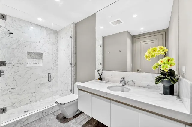 a bathroom with a sink a toilet and a shower