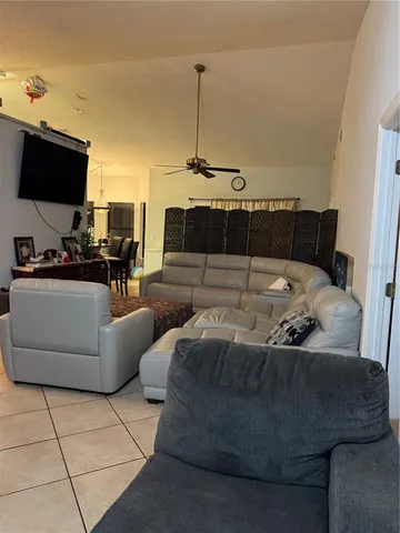 a living room with furniture a rug and a wall painting