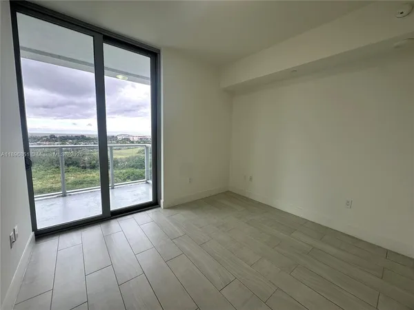 an empty room with wooden floor and closet