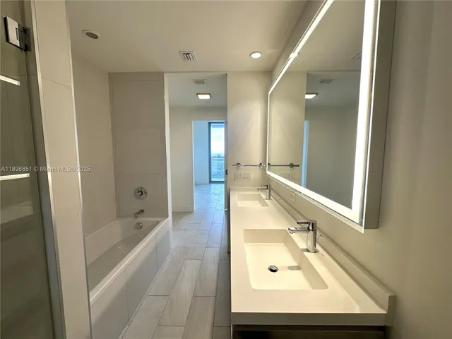a bathroom with a glass shower door
