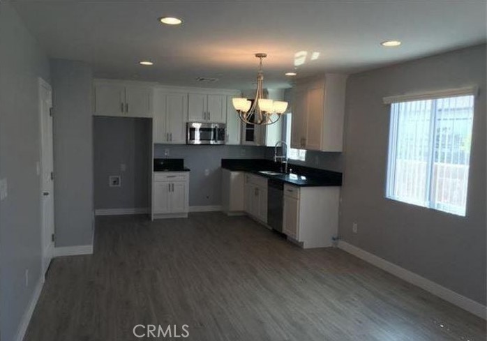 2816 East 3rd Street Los Angeles, CA 90033 - Photo 2 of 8 a kitchen with stainless steel appliances granite countertop a refrigerator a sink dishwasher a stove and a refrigerator
