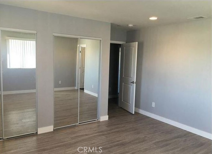 2816 East 3rd Street Los Angeles, CA 90033 - Photo 5 of 8 an empty room with wooden floor & closet area