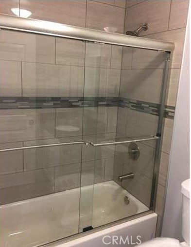 2816 East 3rd Street Los Angeles, CA 90033 - Photo 6 of 8 a bathroom with a glass shower door