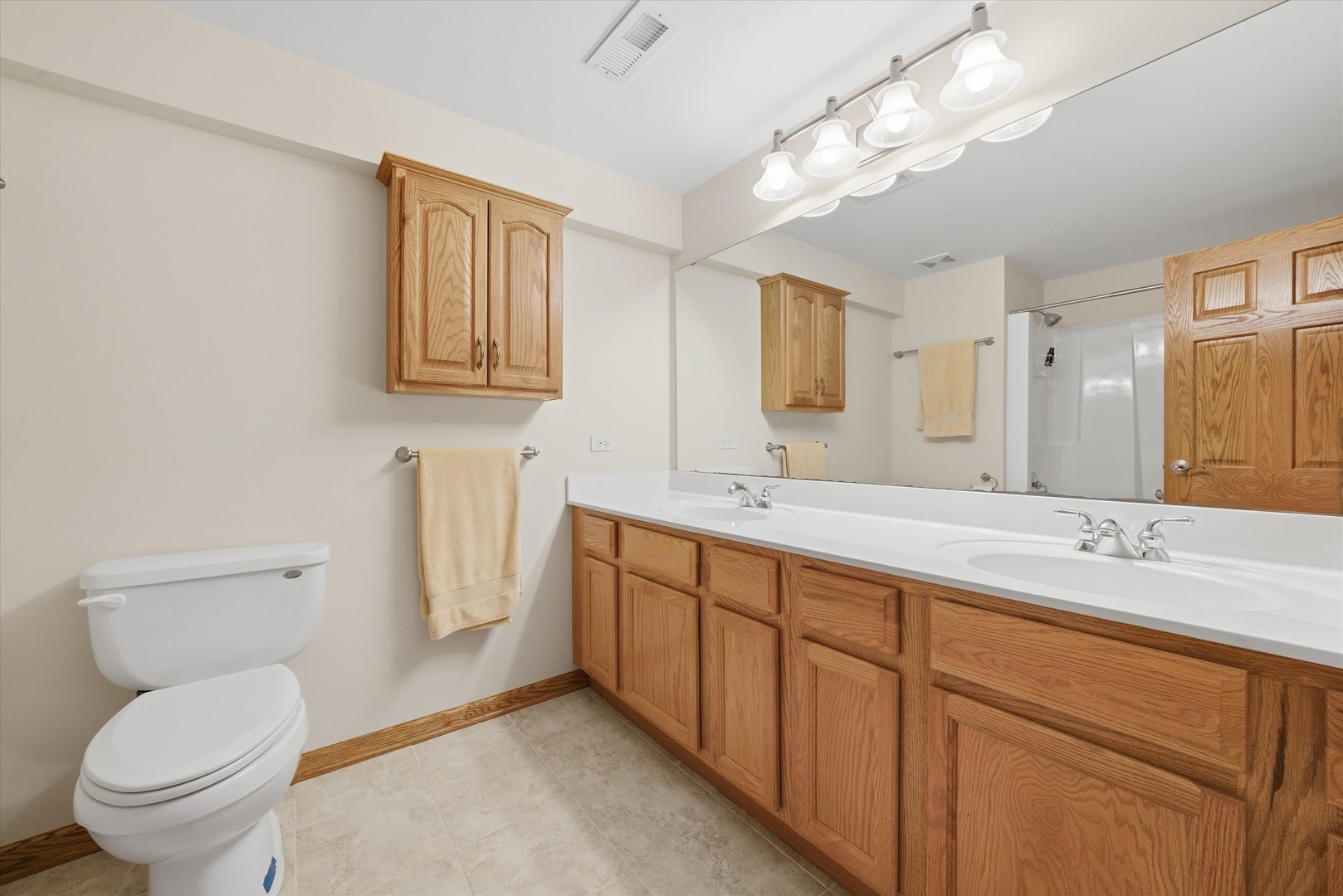 3688 Warwick Drive Crete, IL 60417 - Photo 24 of 27 a spacious bathroom with a granite countertop toilet sink and a mirror