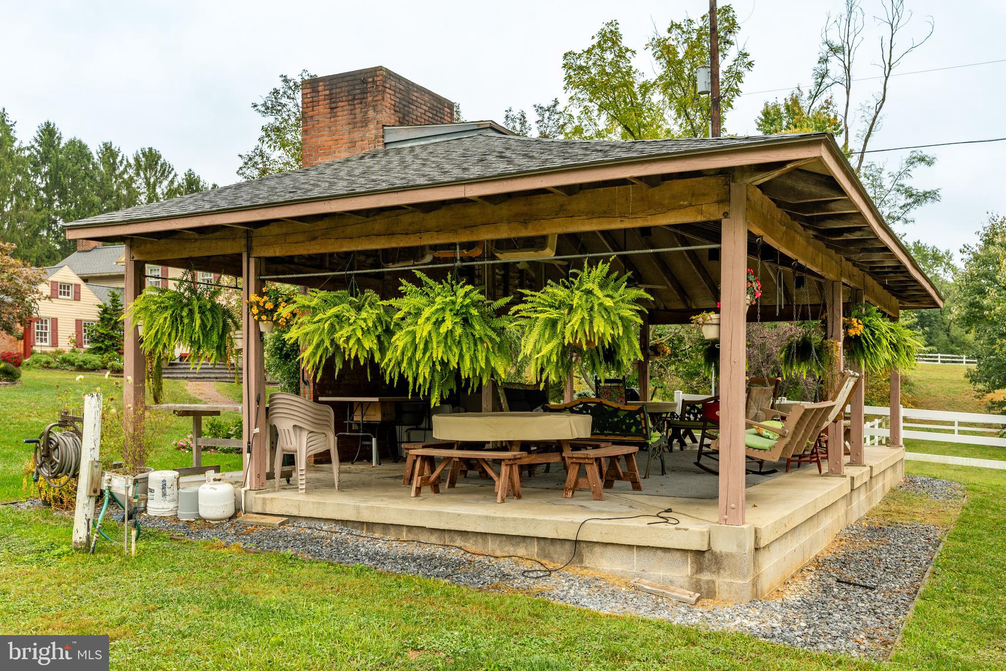 249 Landis Valley Road Lititz, PA 17543 - Photo 28 of 104 a view of a patio with table and chairs potted plants and large tree