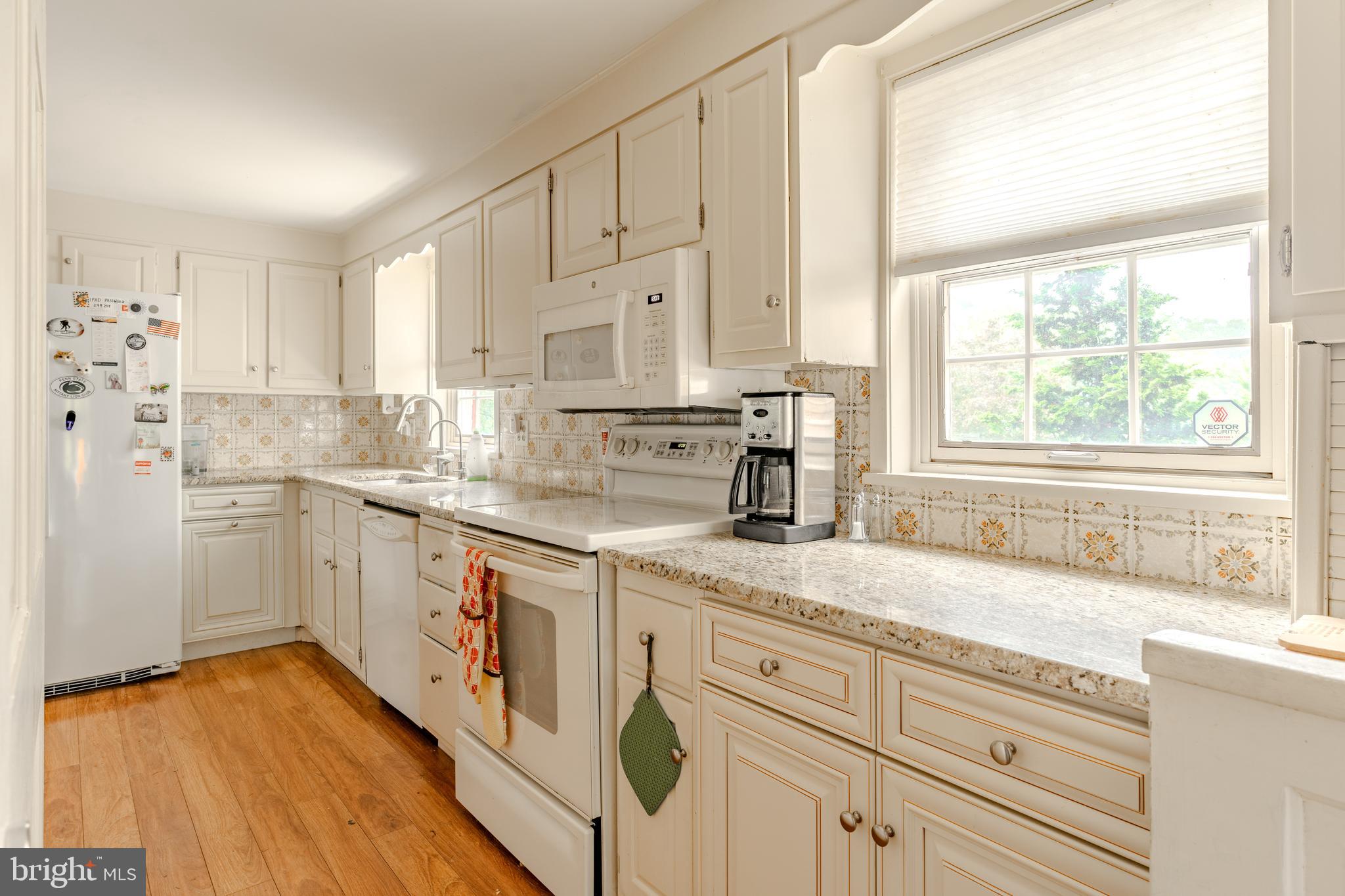 249 Landis Valley Road Lititz, PA 17543 - Photo 53 of 104 a kitchen with granite countertop white cabinets and white appliances