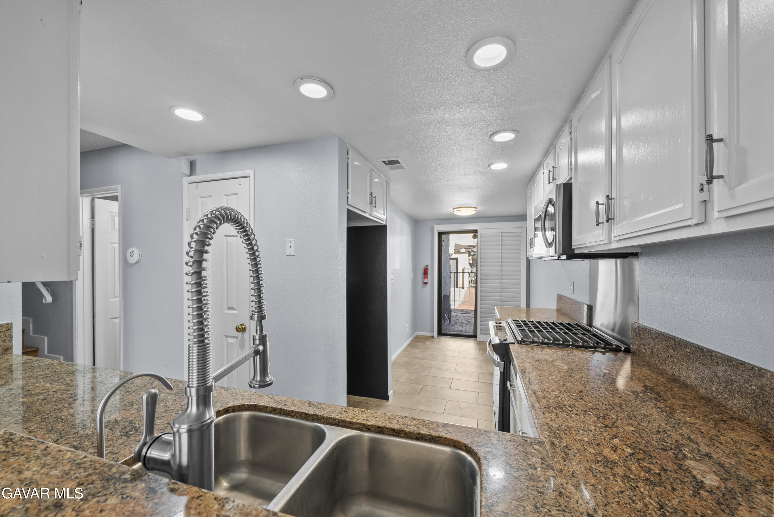 42805 15th Street West Lancaster, CA 93534 - Photo 11 of 27 a kitchen with stainless steel appliances granite countertop a sink a stove and a refrigerator