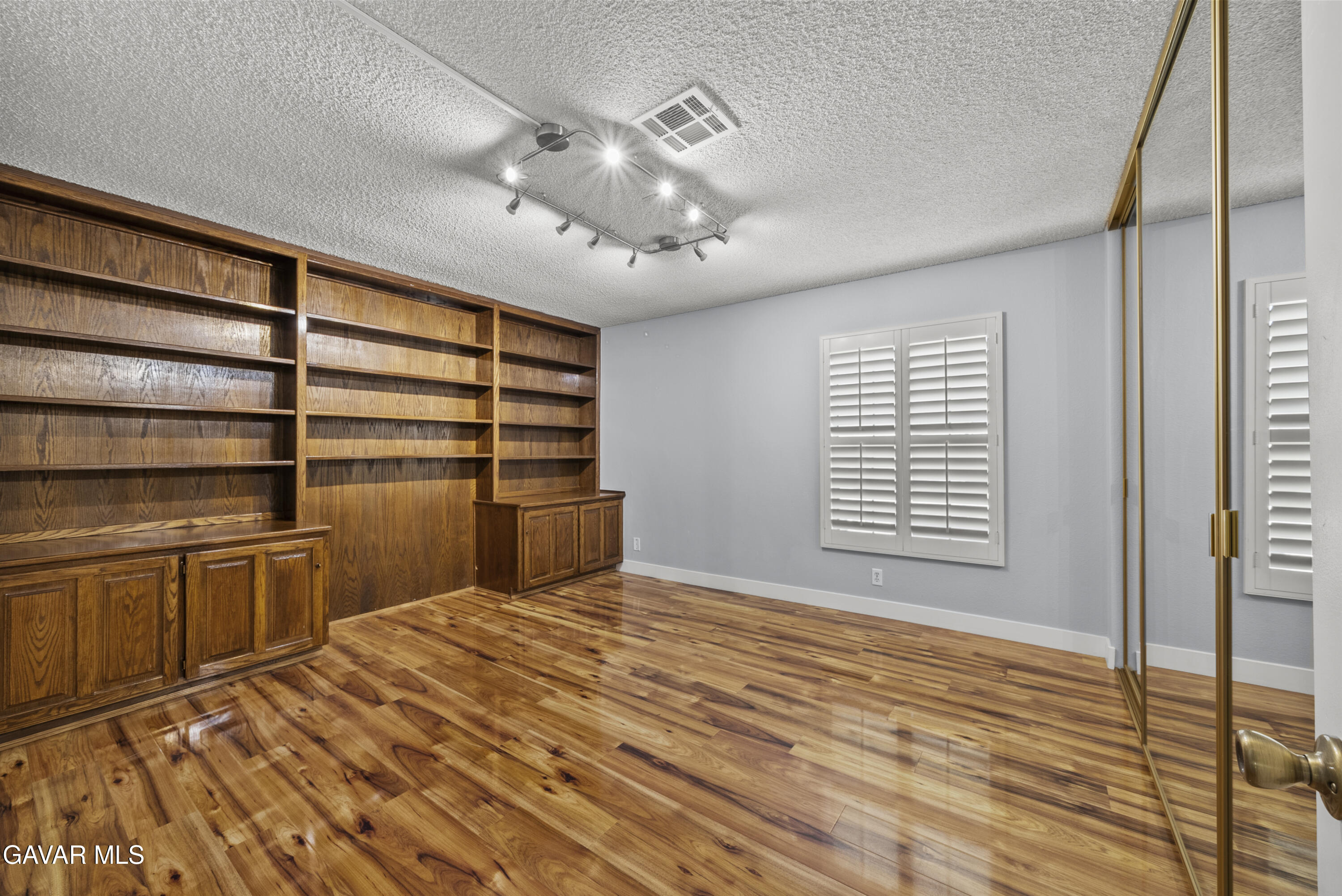 42805 15th Street West Lancaster, CA 93534 - Photo 15 of 27 a view of empty room with wooden floor and fan
