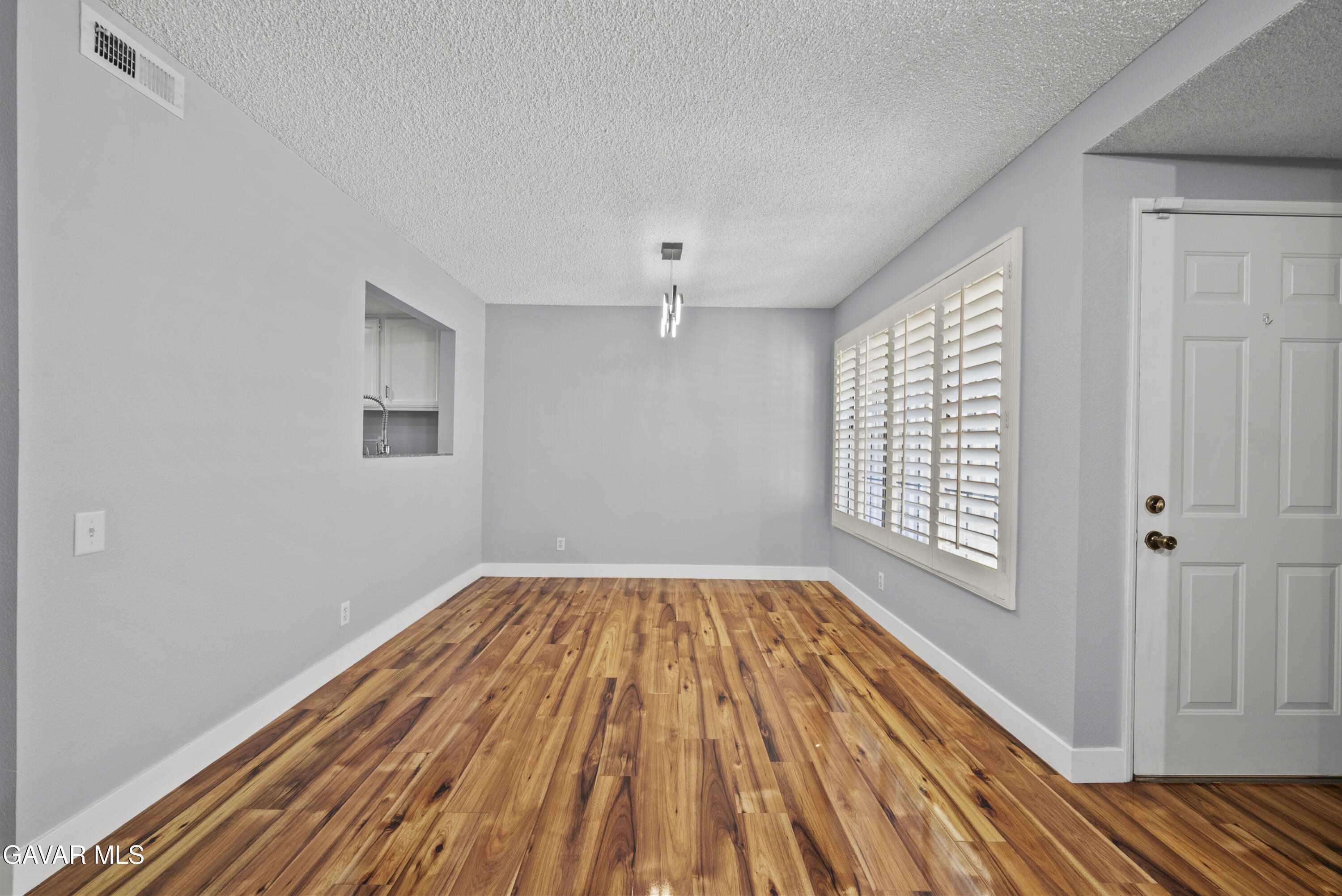 42805 15th Street West Lancaster, CA 93534 - Photo 4 of 27 a view of an empty room with wooden floor and a window