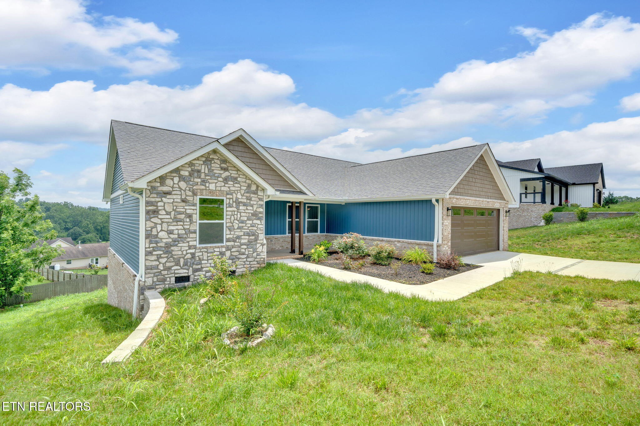 141 Middle Glen Road Maynardville, TN 37807 - Photo 2 of 41 a front view of a house with a yard and garage
